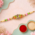 Ornate Rakhi featuring Floral Mirror Medallion, bead line and chain look for Gift Use