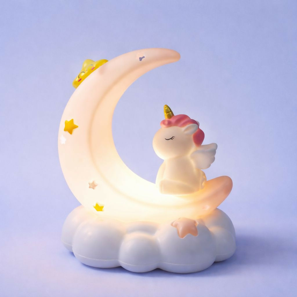 The unicorn crescent moon night light, emitting a warm glow, rests on a light blue backdrop.
