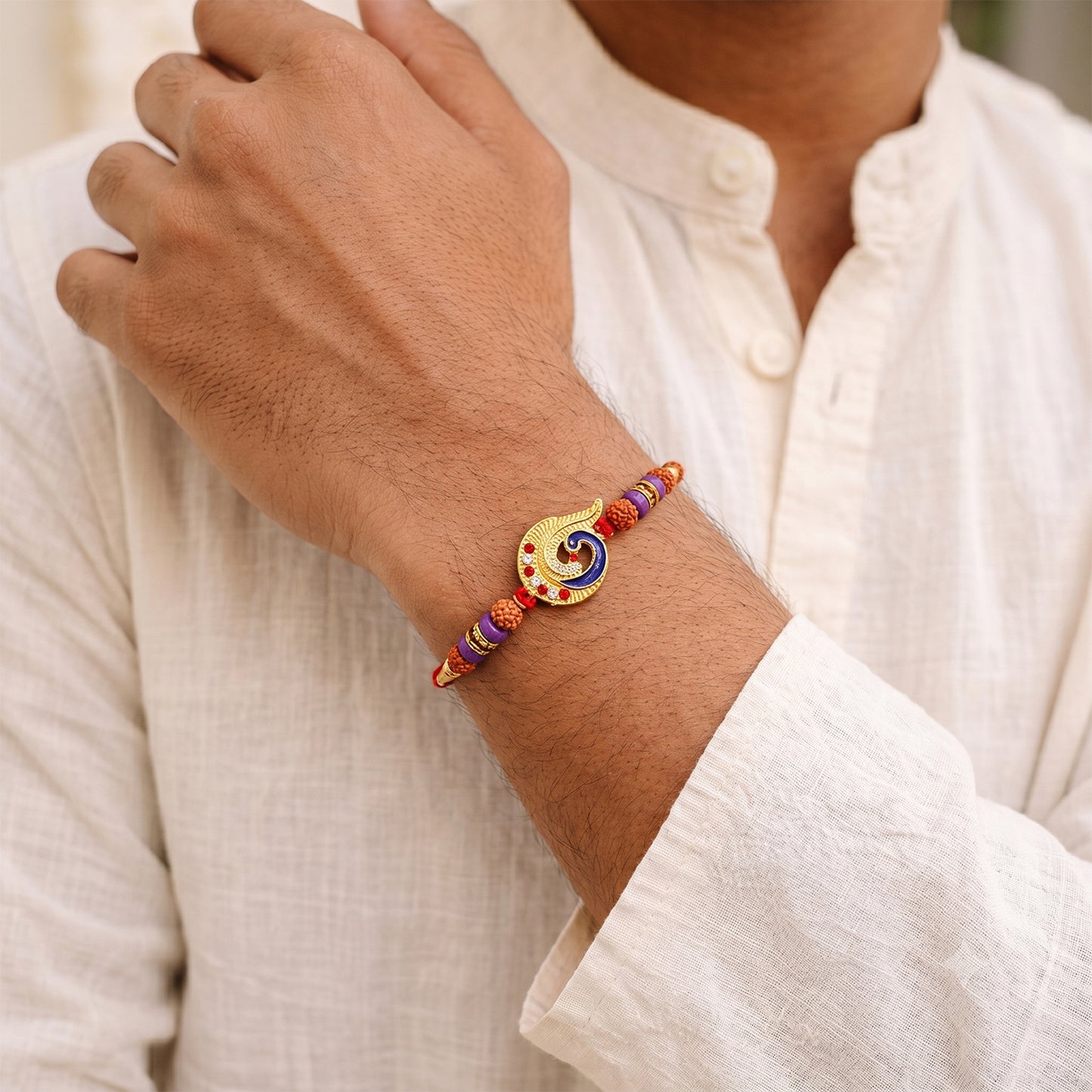 Blue Peacock Rakhi with Purple Beads and Crescent Gold Frame