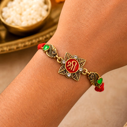 Antique Gold-Toned Shree Rakhi with Crystal Accents, Green Enamel & Designer Red Thread