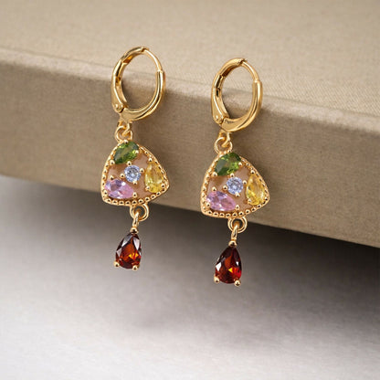 Side view of gold-tone multicolor stone drop earrings with sparkling triangular charm