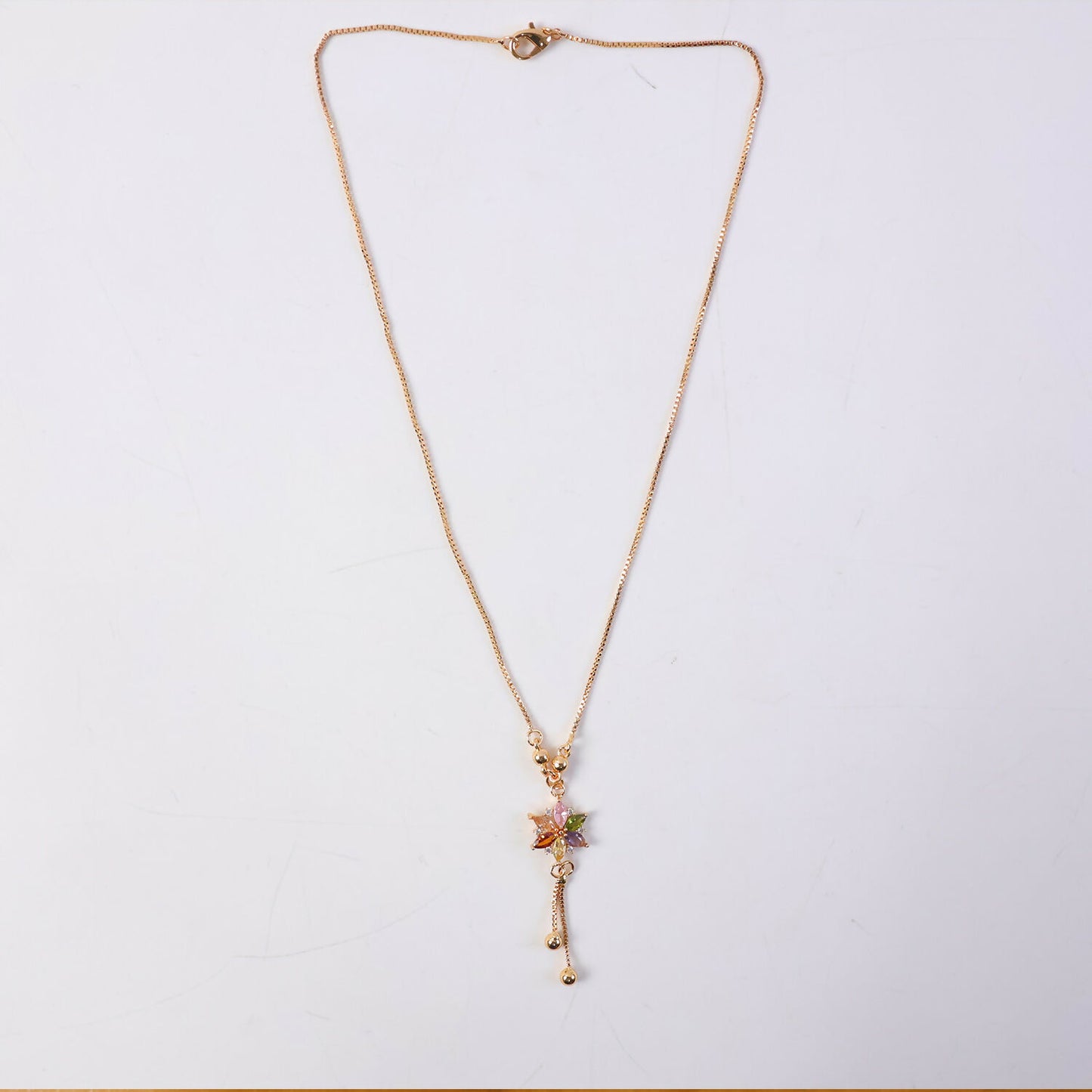 Styled look with multicolor crystal flower pendant and gold chain