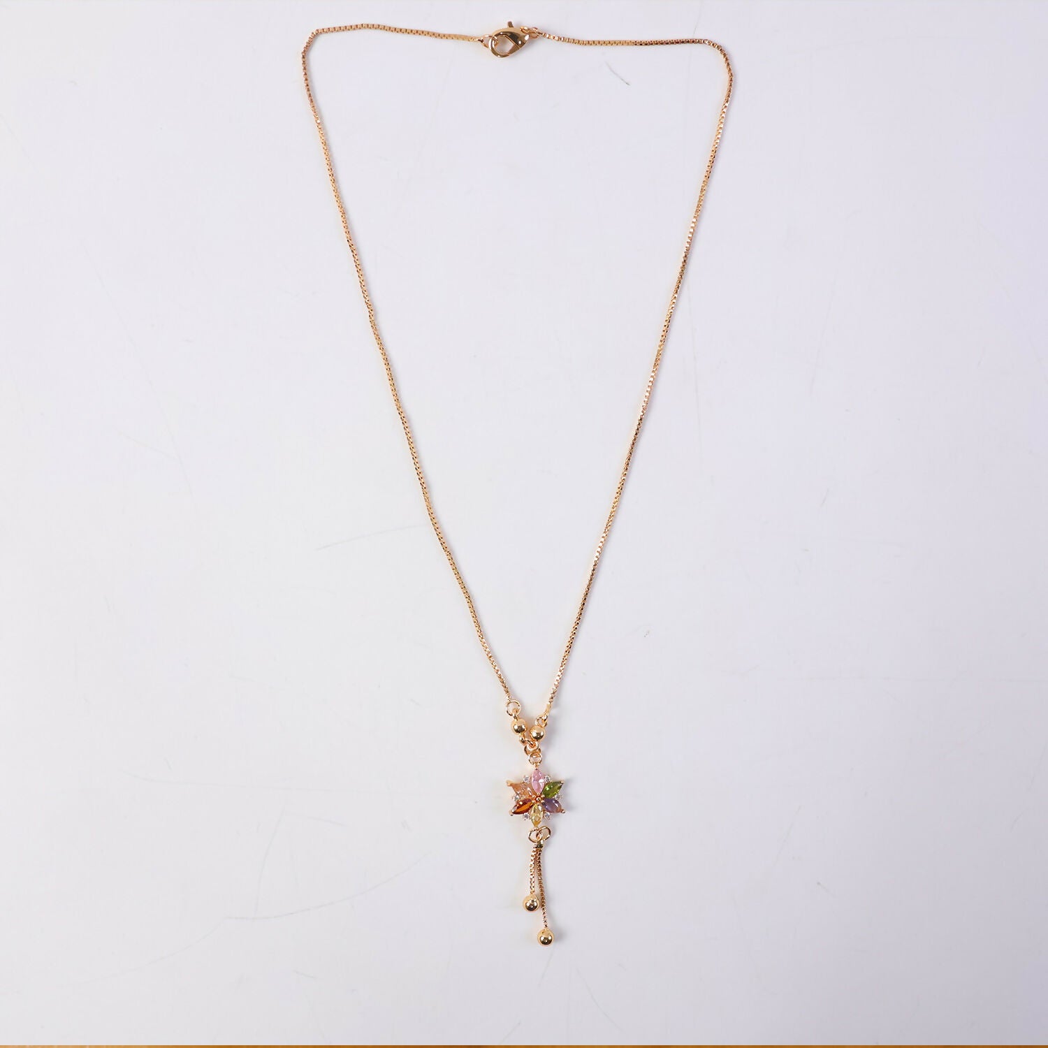 Styled look with multicolor crystal flower pendant and gold chain