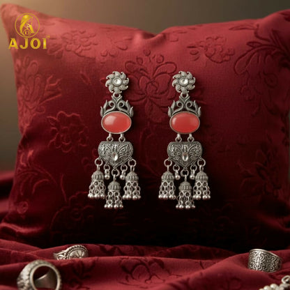Vintage-Inspired Oxidized Silver Red Stone Jhumka Earrings with Ornate Filigree Design and Cascading Bell Danglers