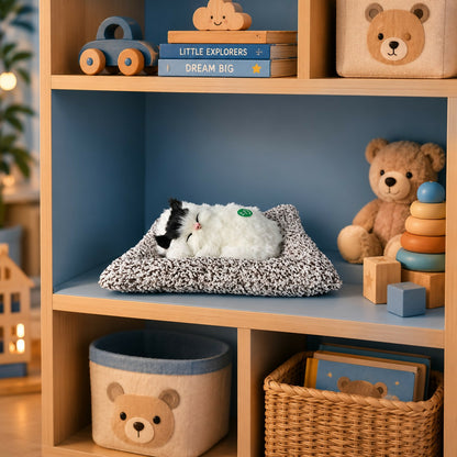 Side view of sleeping cat plush toy with soft fur texture