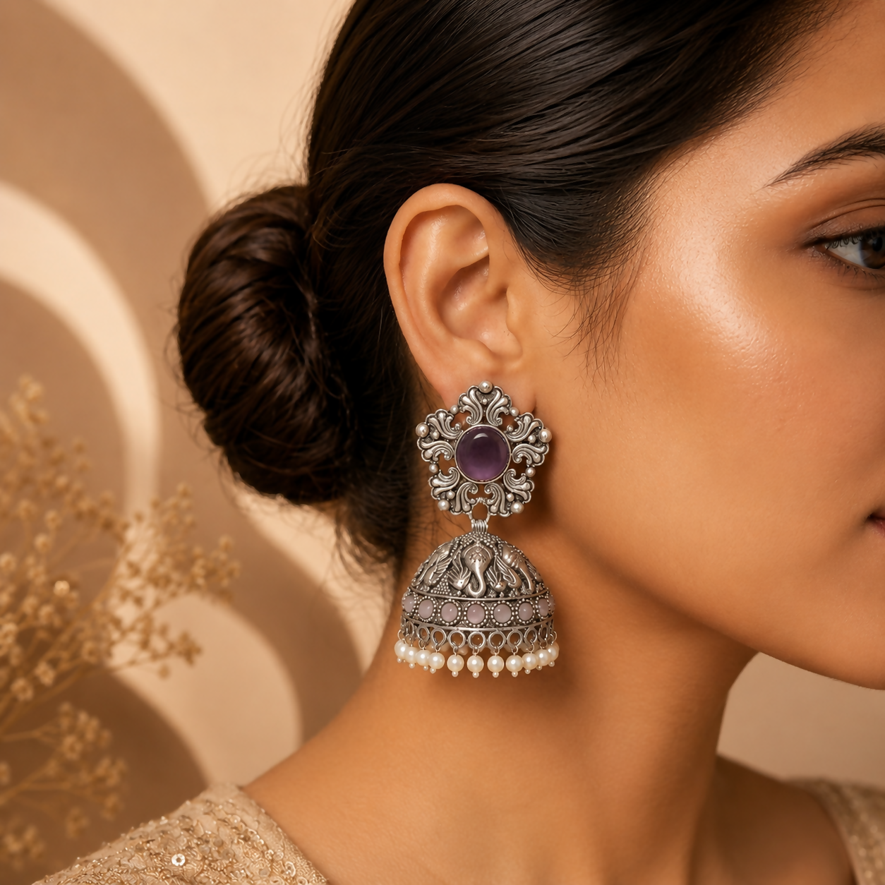 Close-up of handcrafted oxidized silver jhumka earrings with purple stones