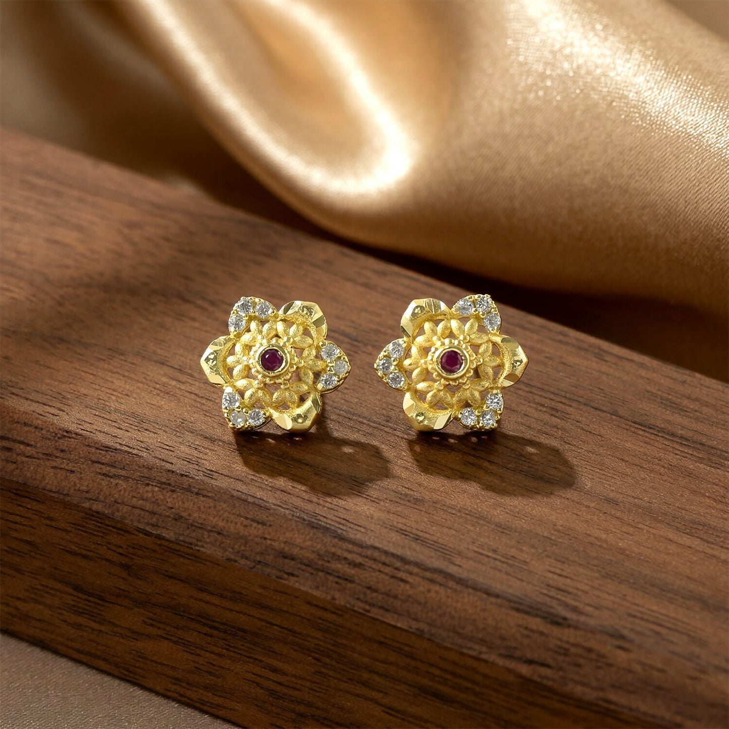 Elegant floral gold stud earrings with shining center stone