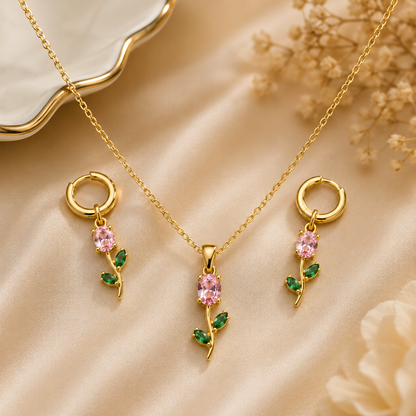 Close up view of the pink crystal floral pendant with green leaf design.