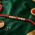 Red Cord Rakhi with Rudraksha and Natural Wooden Bead Accents