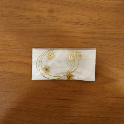Gold chain necklace with secure clasp and floral star design