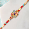 Jewel Floral Rakhi with Red Blue Beads and Bright Traditional Celebration Styling