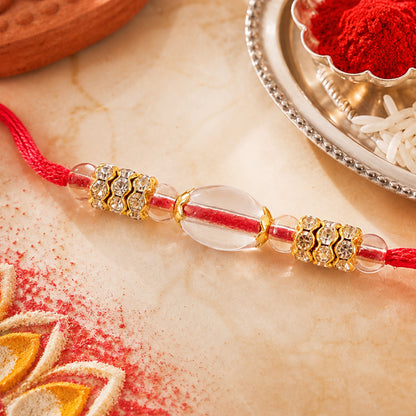 Red Thread Rakhi with Oval Crystal Bead Pendant and Golden Finish