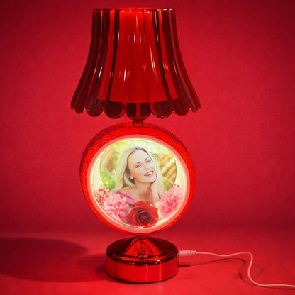 Close-up of red round photo table lamp with illuminated photo