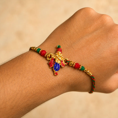 Lord Krishna Flute Pendant Rakhi with Red and Green Beads