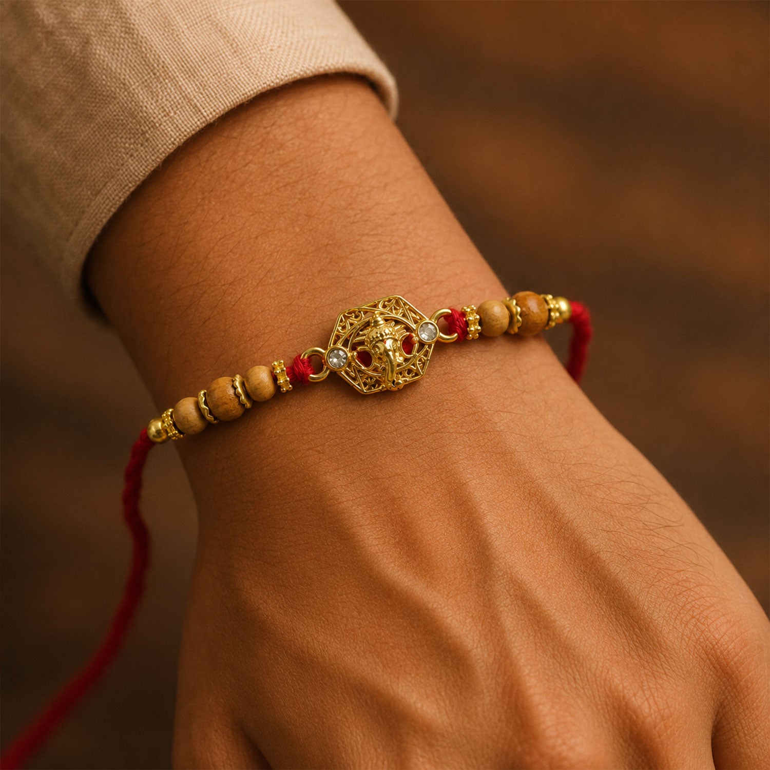 Ganesh Temple Devotional Rakhi with Golden Centre, Wooden Beads and Red Thread