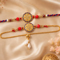 Stone Studded Round Bhai Bhabhi Lumba Rakhi with Pearl Hangings
