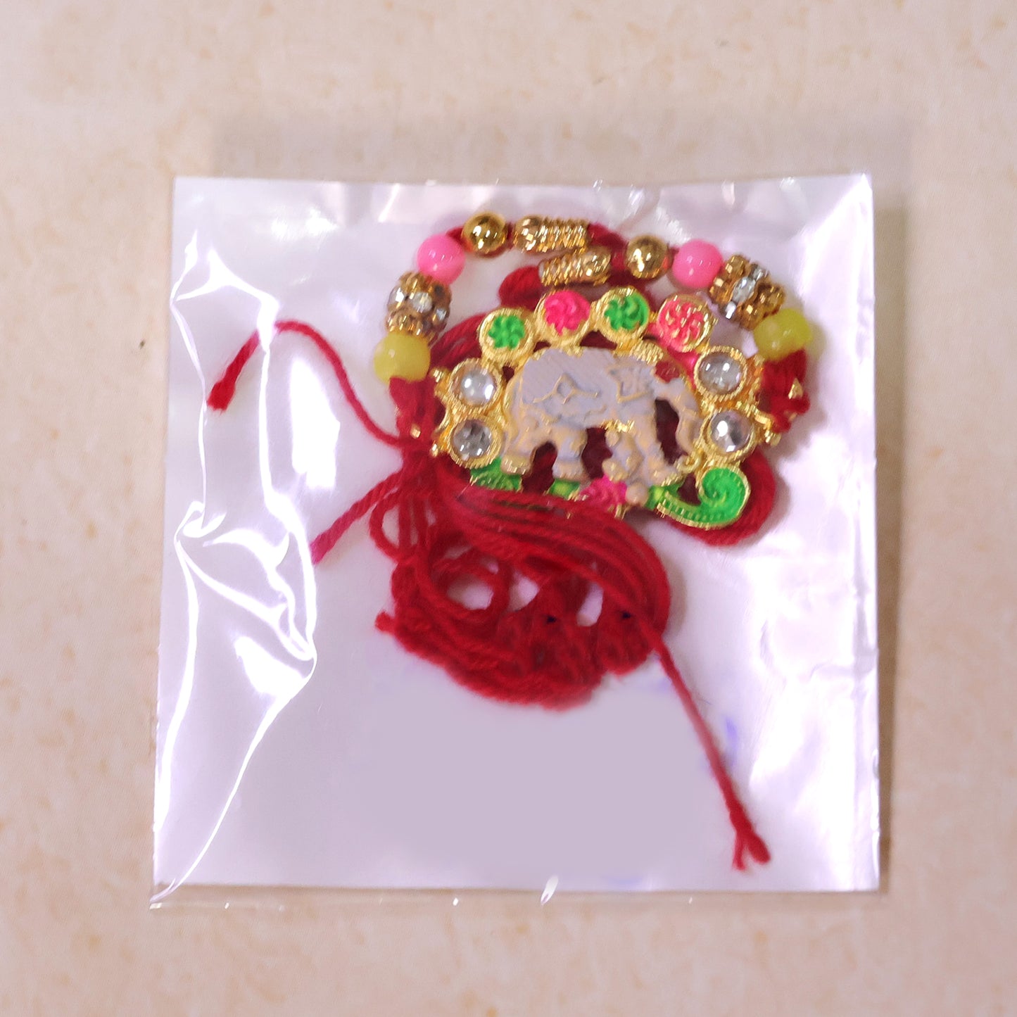 Festive Rakhi featuring Elephant Charm and gold trims in display look for Gift Use