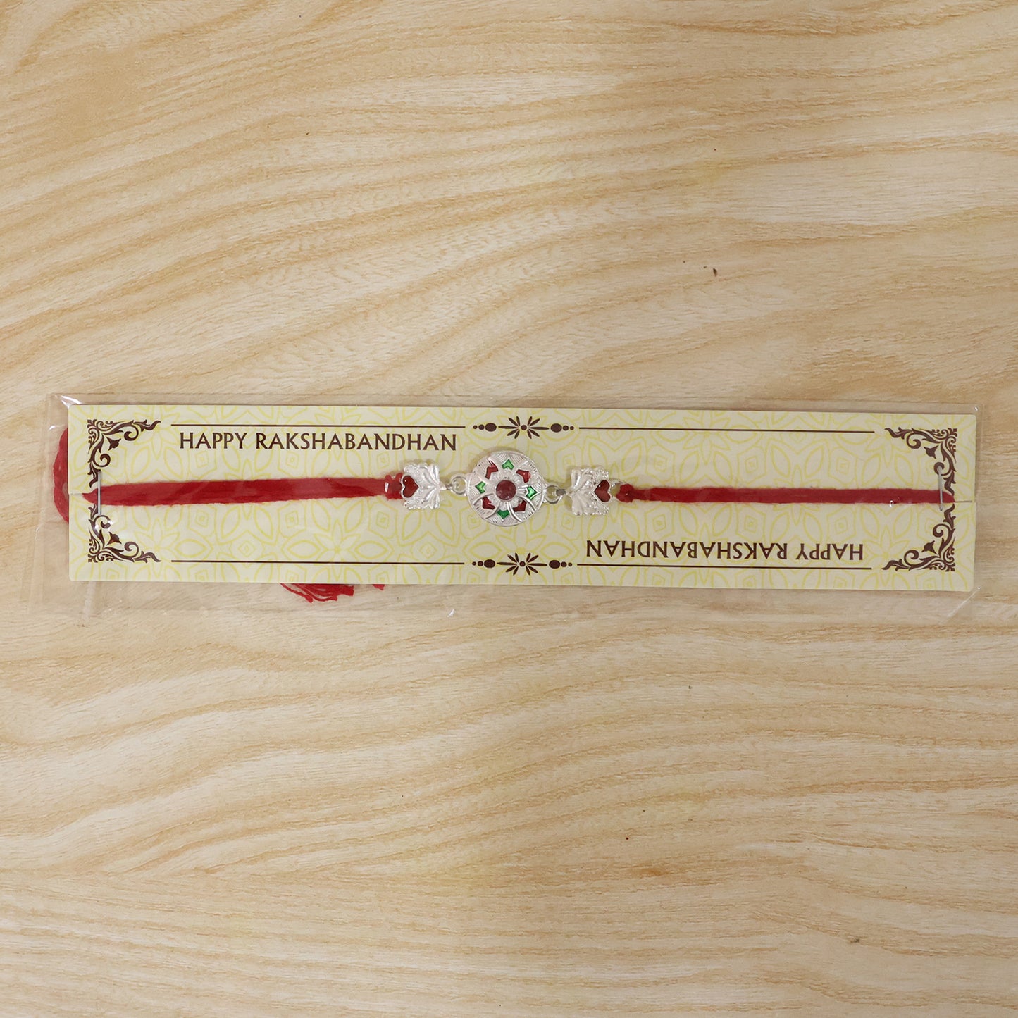 Silver Decorative Rakhi for Boys with Red and Green Accents