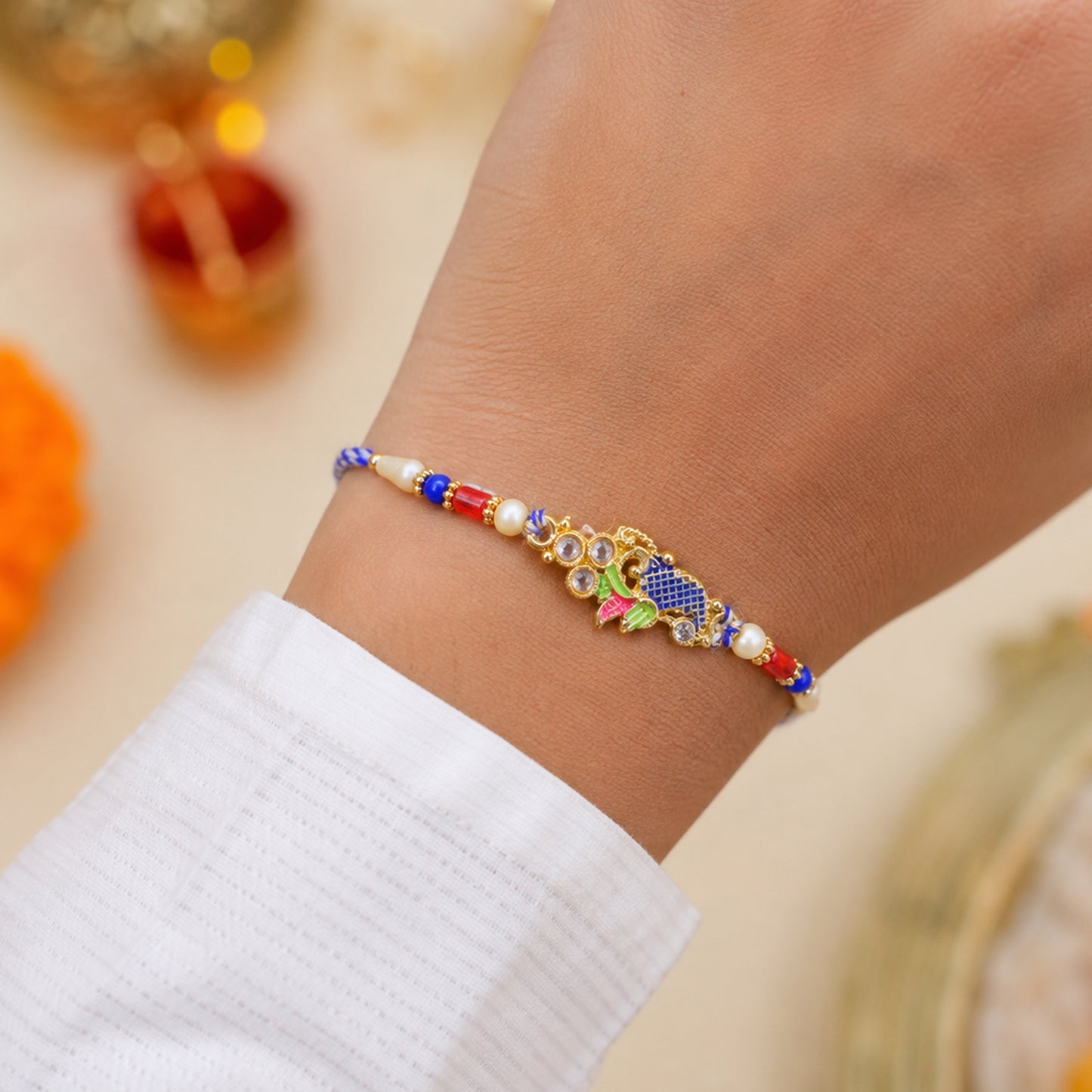 Peacock Motif Rakhi with Red Blue Beads and Elegant Traditional Gift Presentation