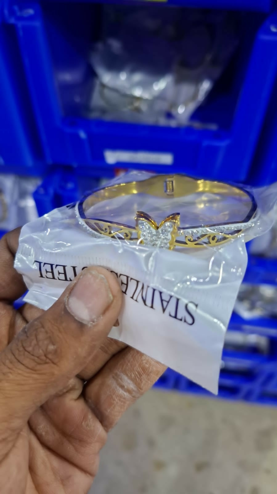 Gold-tone botanical kada bracelet detail shot with daisy motif