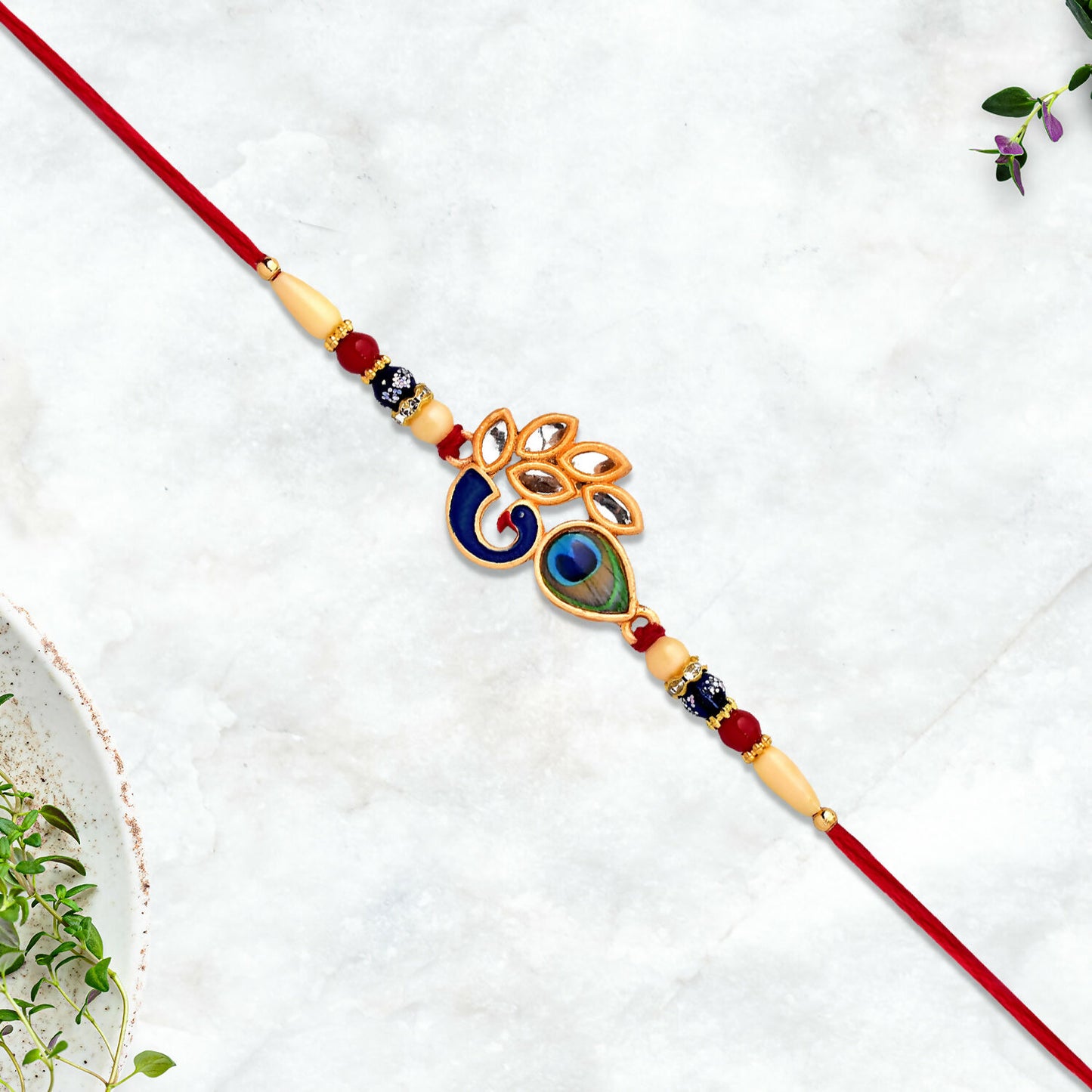 Close-up of Mor Pankh Rakhi with traditional thread