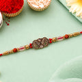 Oxidized Gold Paisley Medallion Rakhi with Rudraksha and Pearl Beads