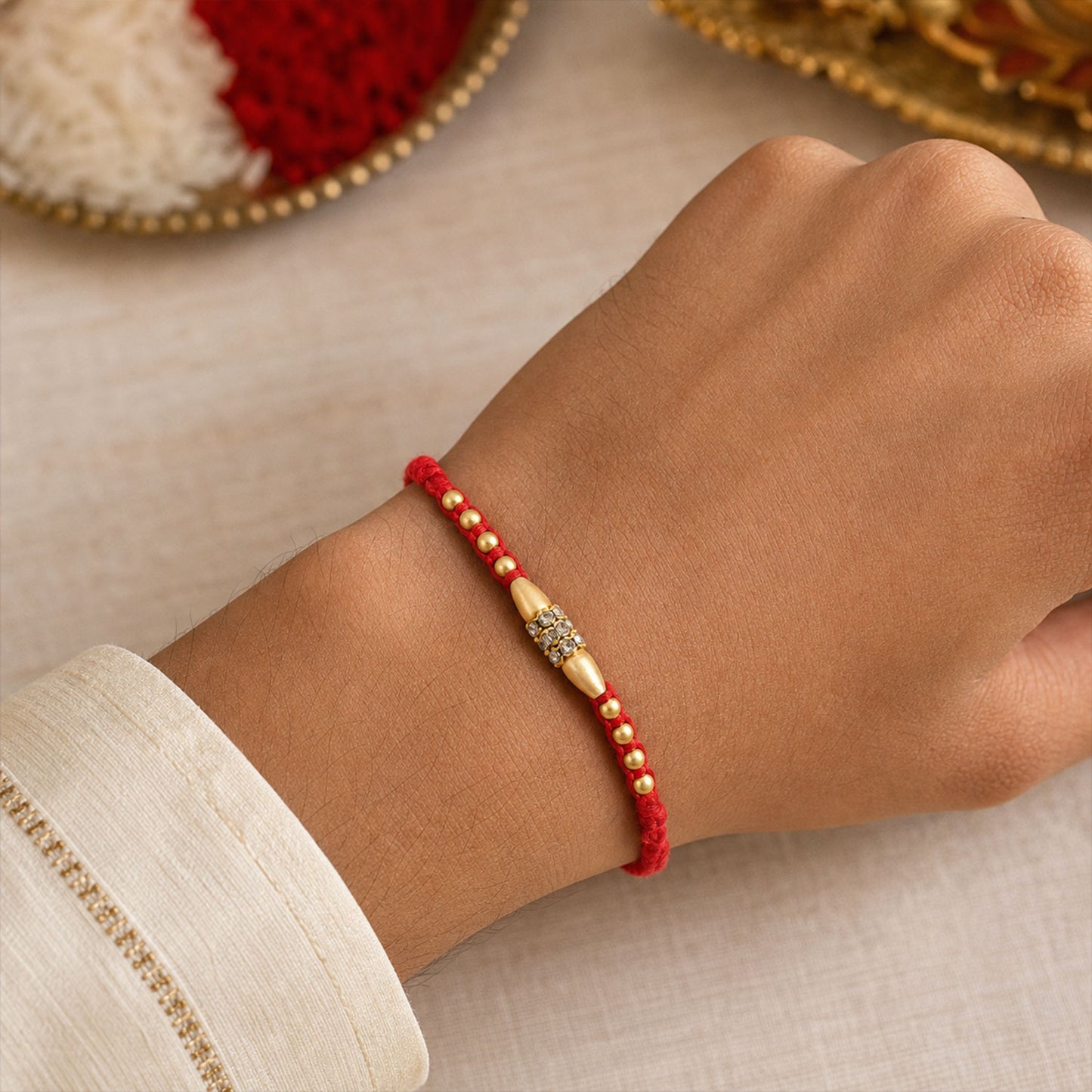 Minimal Red Thread Rakhi with Small Golden Bead Pendant Accents