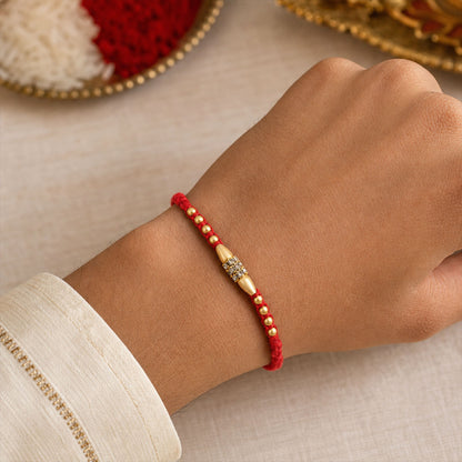 Minimal Red Thread Rakhi with Small Golden Bead Pendant Accents