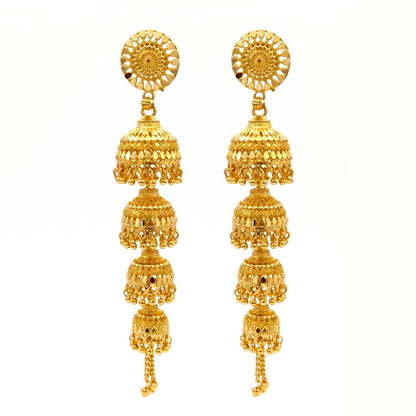 Woman wearing gold jhumka earrings, side profile