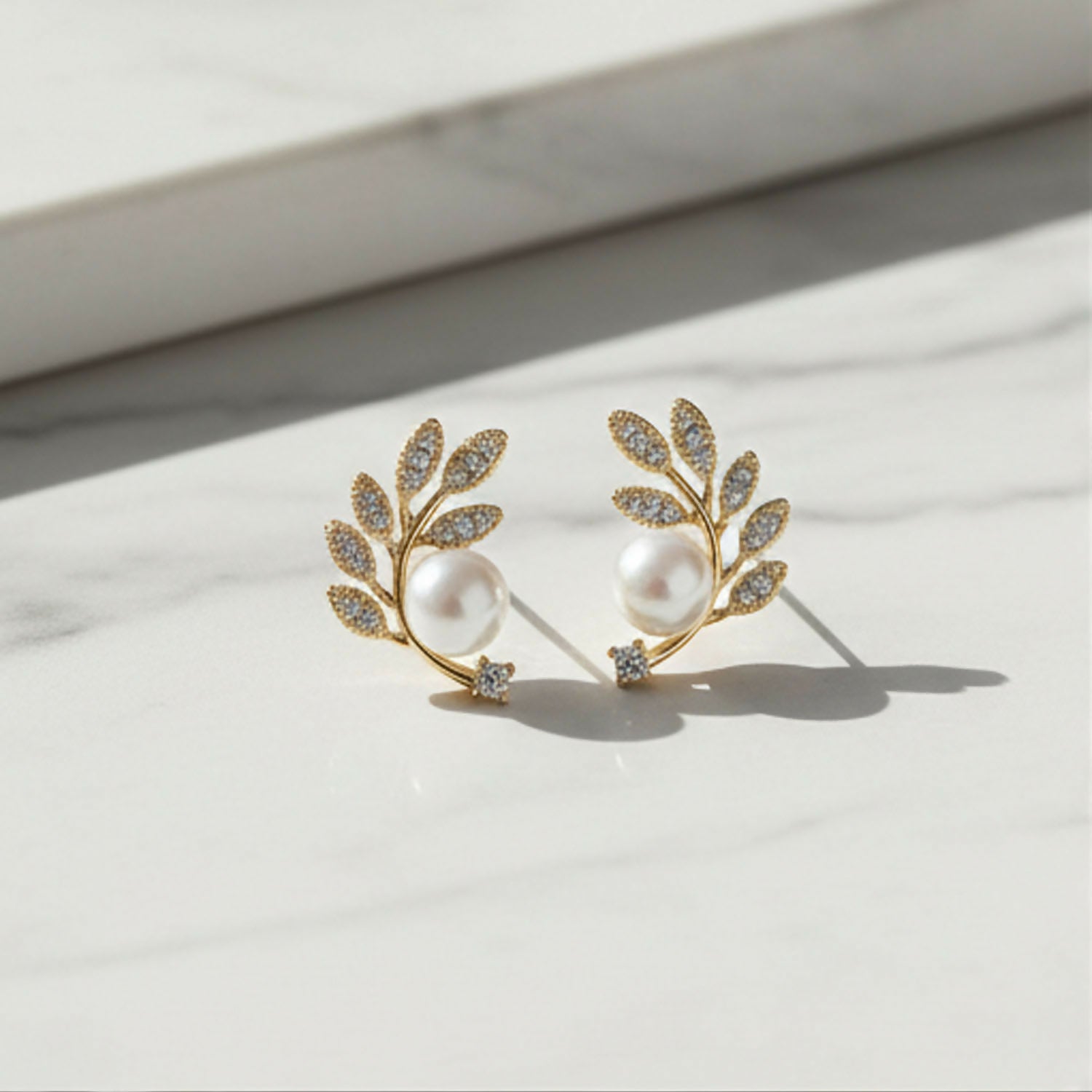 Crystal and pearl details on botanical ear climbers