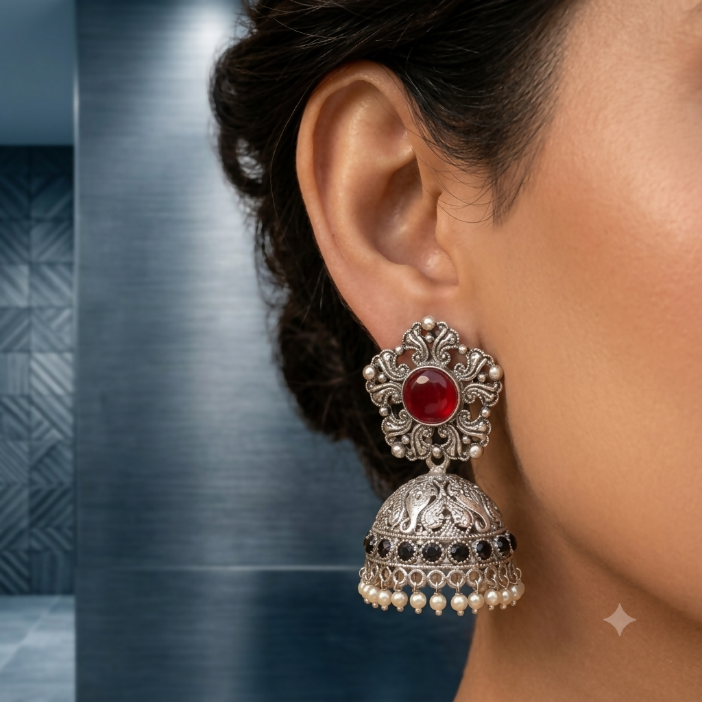 Oxidized silver jhumka earrings with ruby stones front view