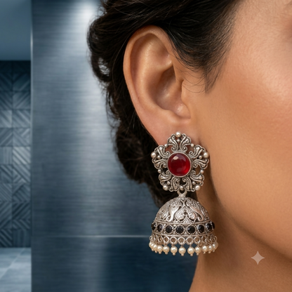 Oxidized silver jhumka earrings with ruby stones front view