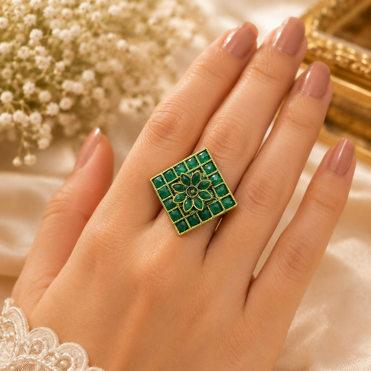 Elegant green floral statement ring worn on a woman's finger, showcasing its design