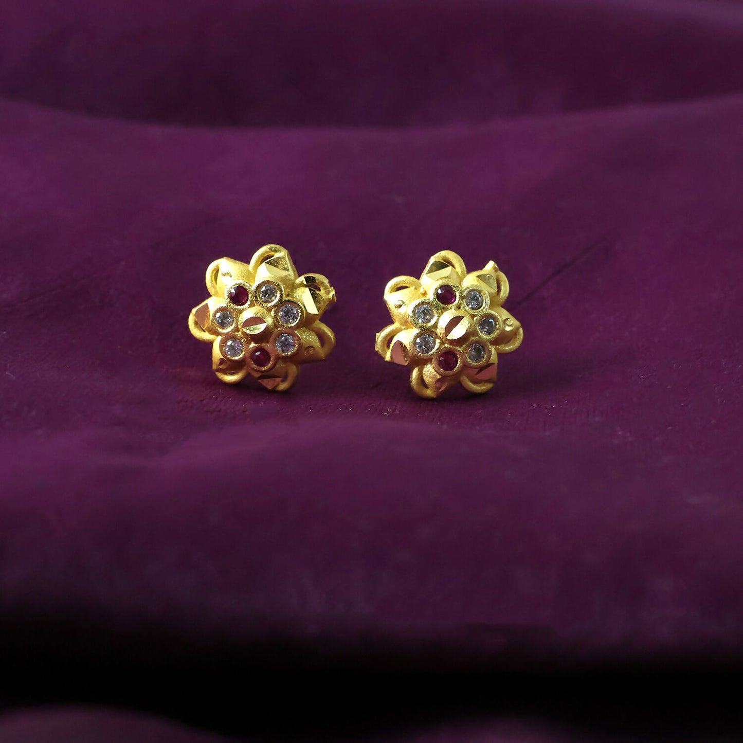 Side view of floral-shaped stud earrings with sparkling crystals