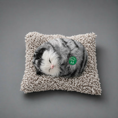 Side view of sleeping cat plush toy on cushion