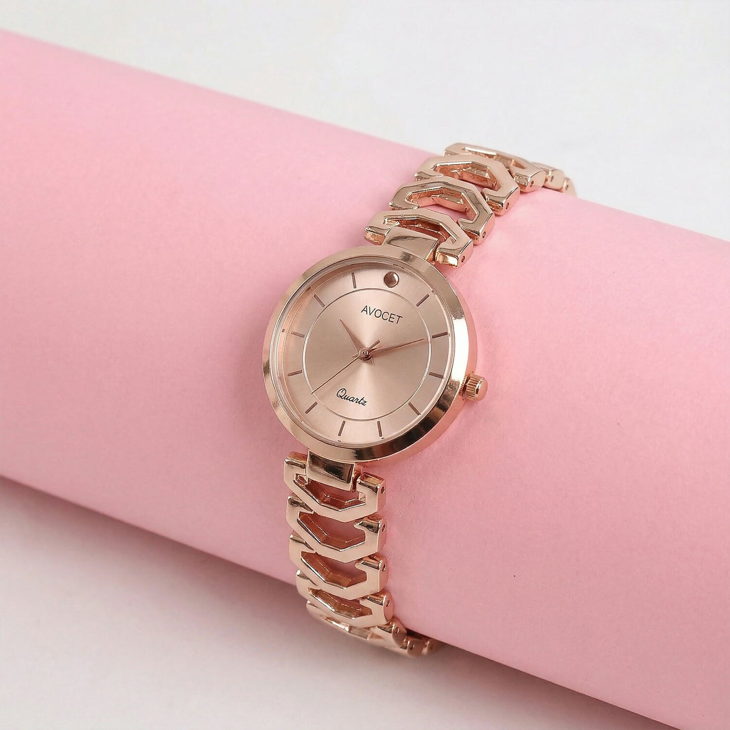 Elegant rose gold watch on wrist with office outfit