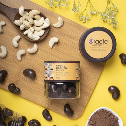 Oracle chocolate coated cashews presented on a white plate alongside whole cashew nuts, highlighting ingredients.