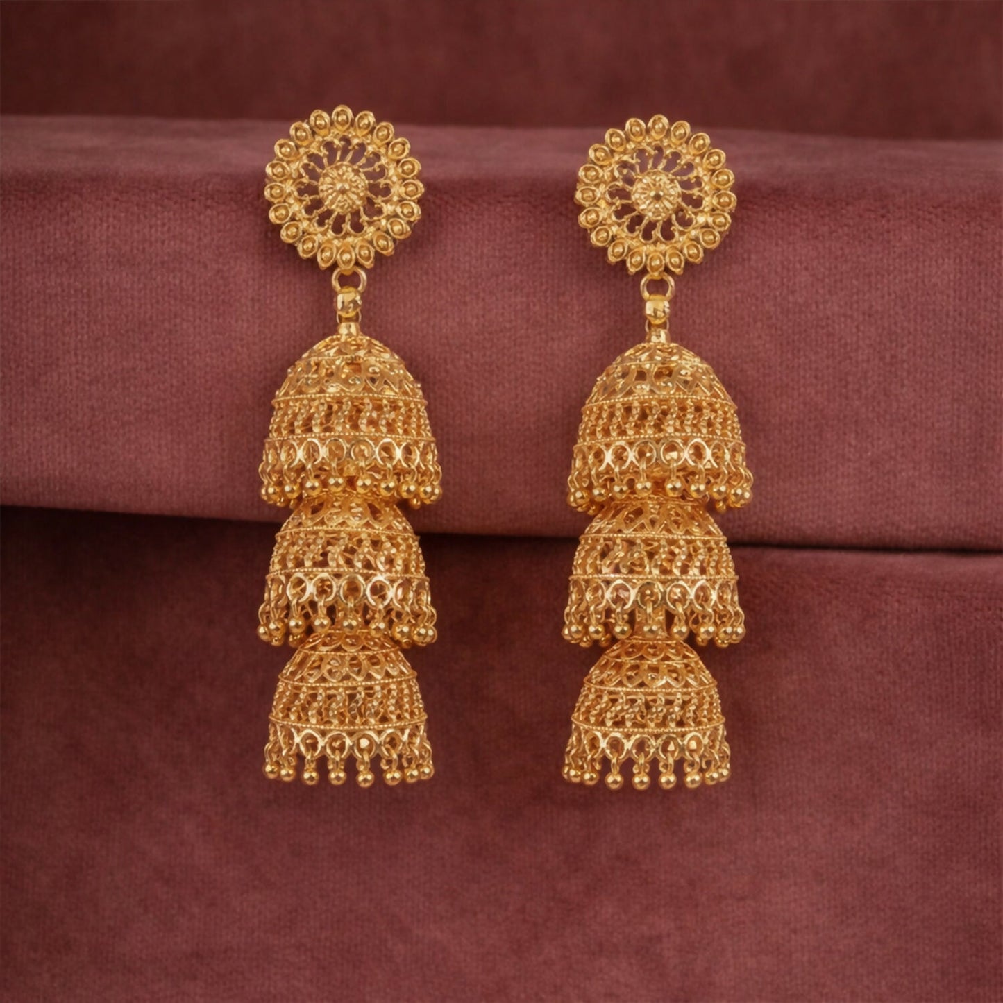 Gold tone traditional Indian jhumka earrings with floral design