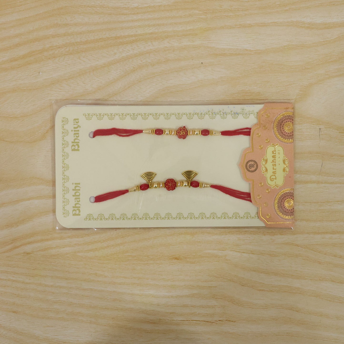 Bhai Bhabhi Floral Charm Rakhi Set with Red Thread, Gold Beads and Black Fan Drops