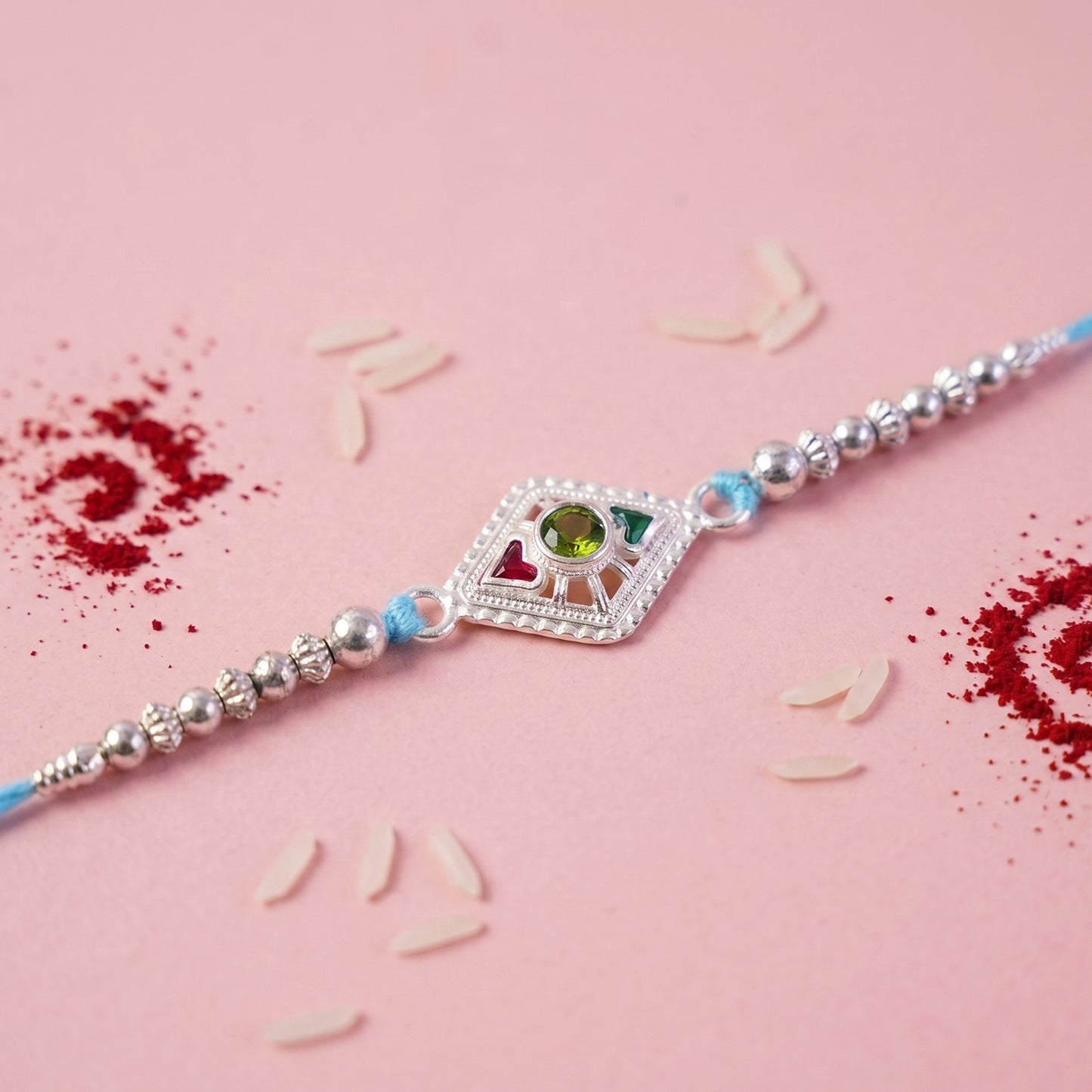 Silver Diamond Kundan Rakhi with Green Stone and Blue Beads