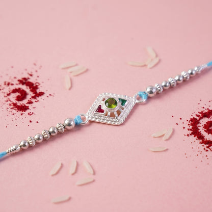 Silver Diamond Kundan Rakhi with Green Stone and Blue Beads