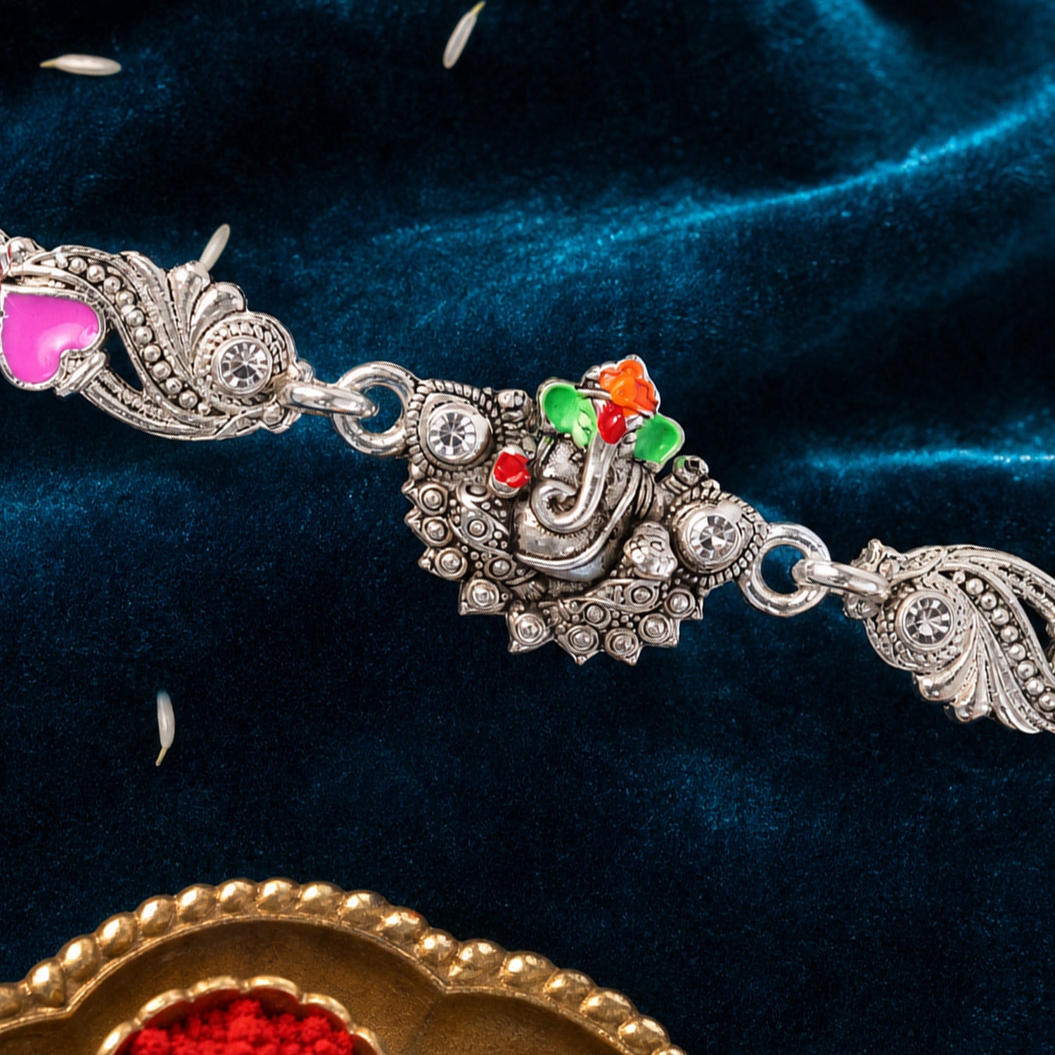 Silver-Toned Lord Ganesha Rakhi with Floral Design, Crystal Accents & Designer Red Thread