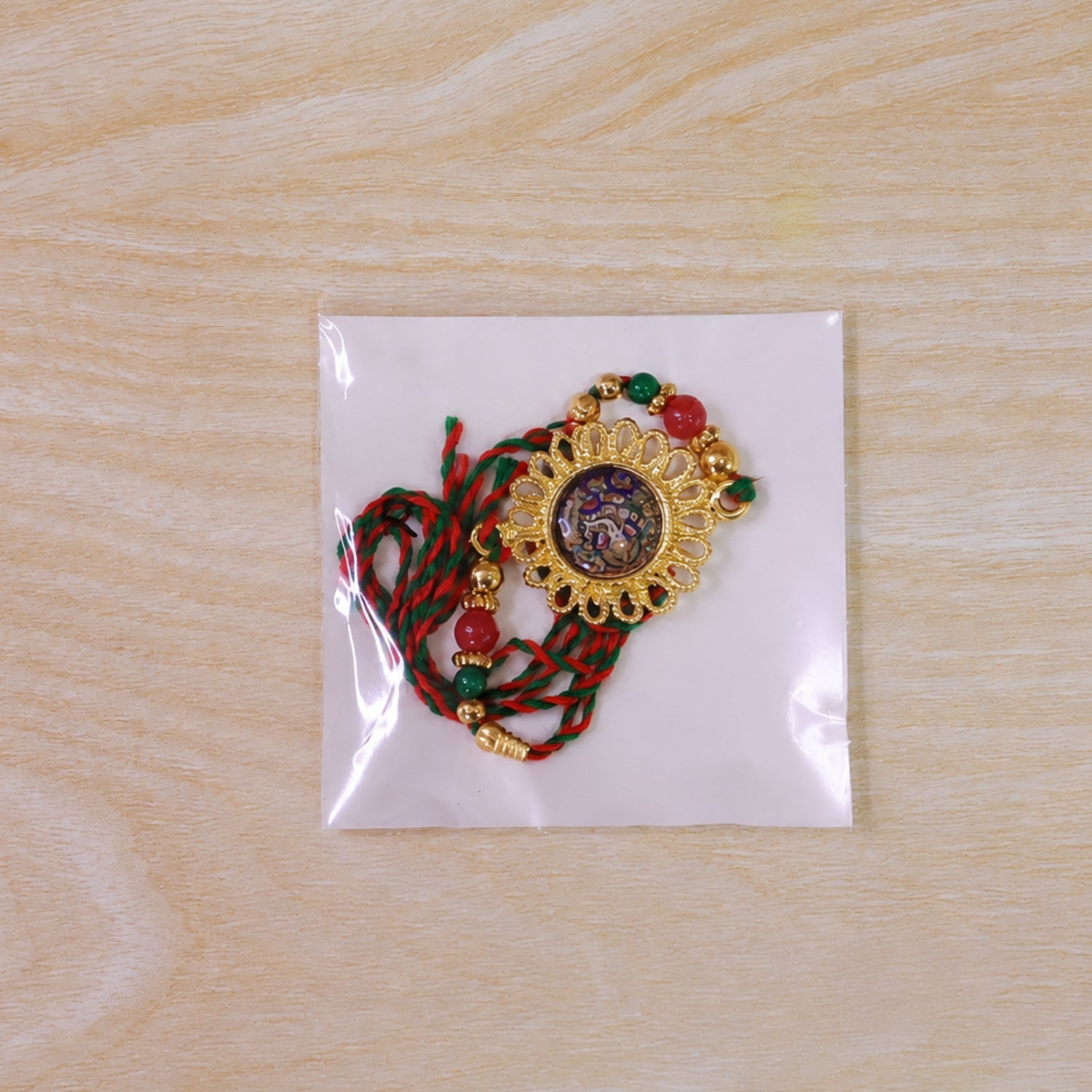 Hand Painted Ganesha Medallion Rakhi with Red Beads