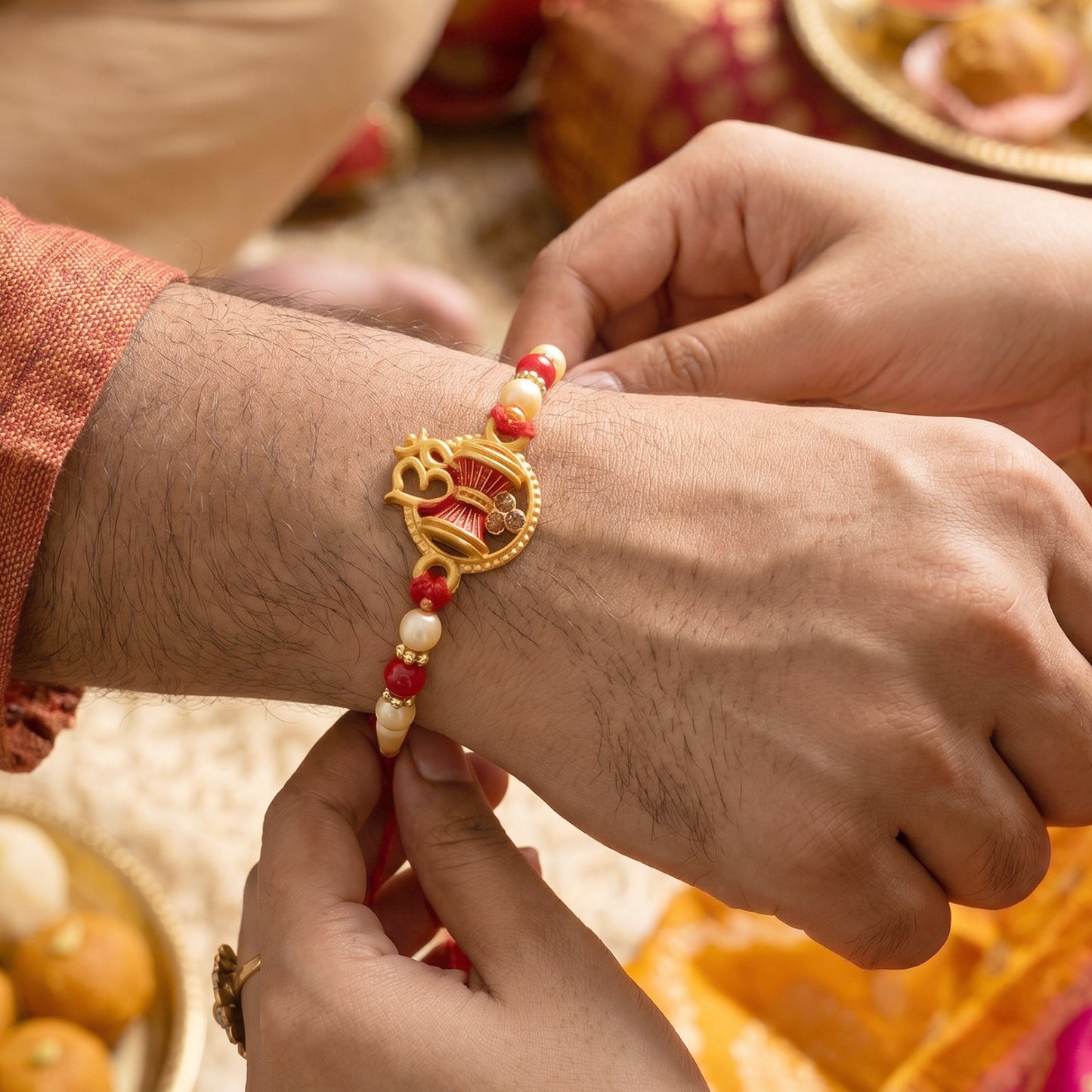 Golden Damru Om Rakhi for Boys with Red and White Beads