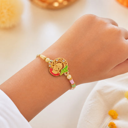 Textured Gold Om Pendant Rakhi with Leaf Accent and Pearl Beads