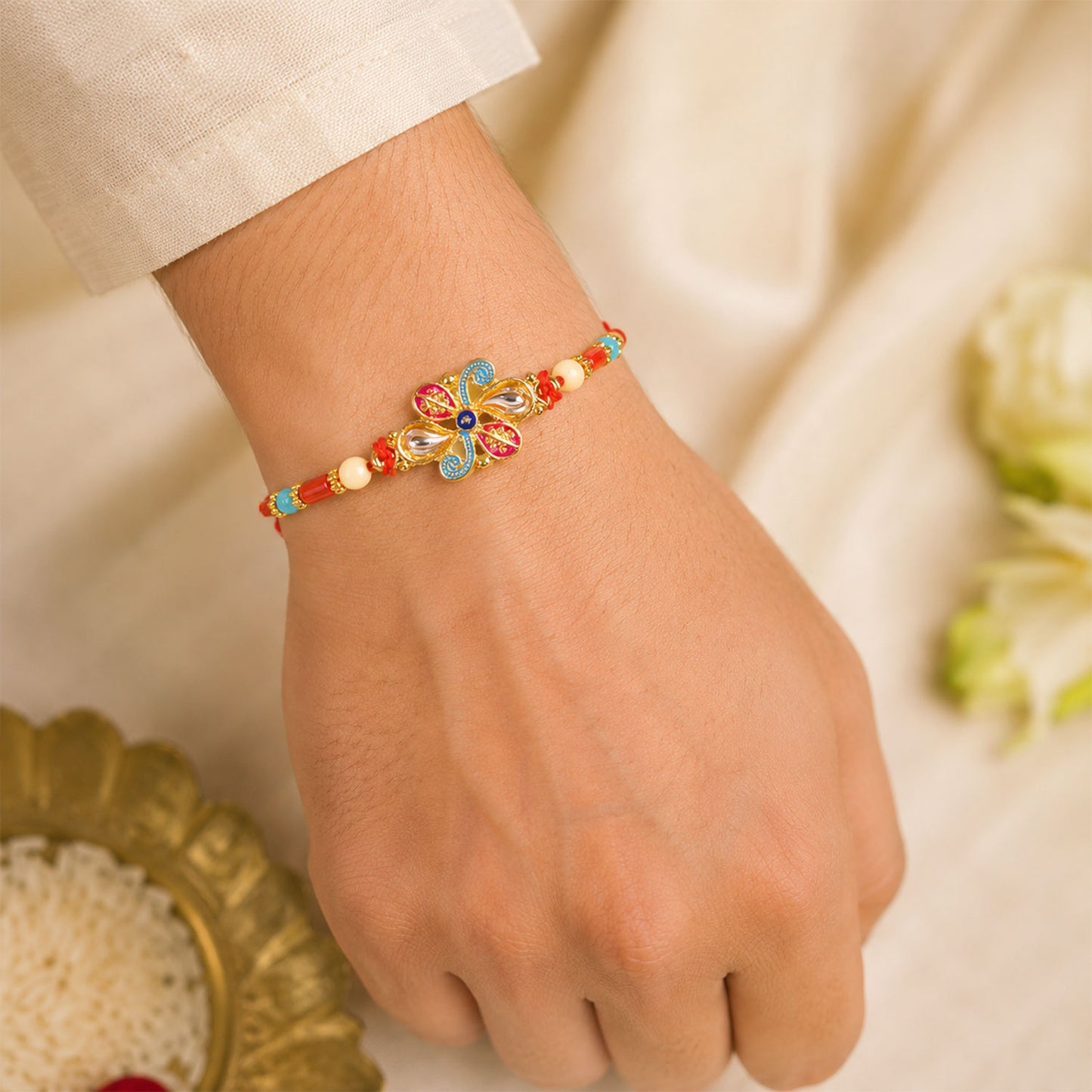 Jewel Floral Rakhi with Red Blue Beads and Bright Traditional Celebration Styling