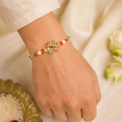 Jewel Floral Rakhi with Red Blue Beads and Bright Traditional Celebration Styling