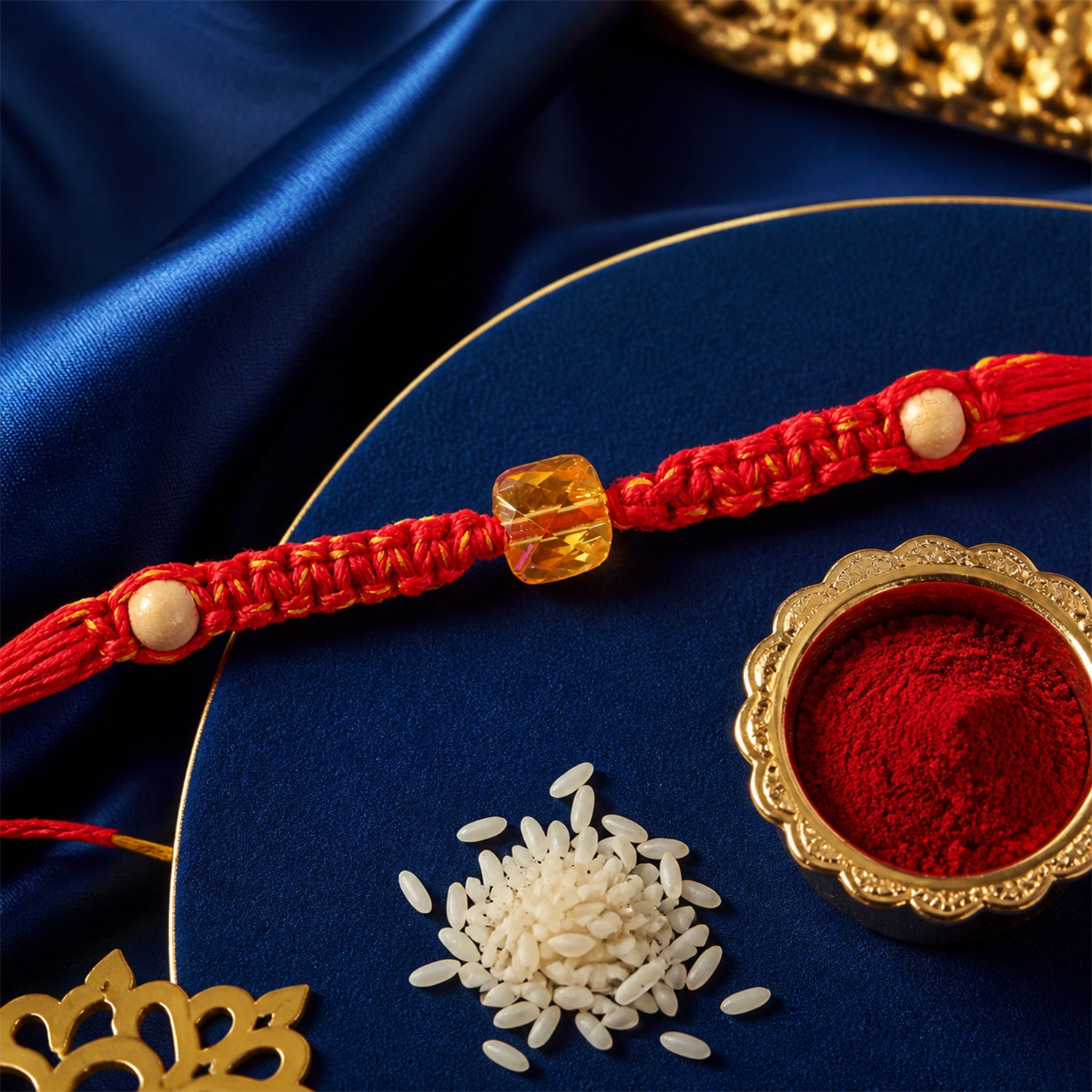 Red Thread Rakhi with a Faceted Amber-Toned Crystal Cube Bead
