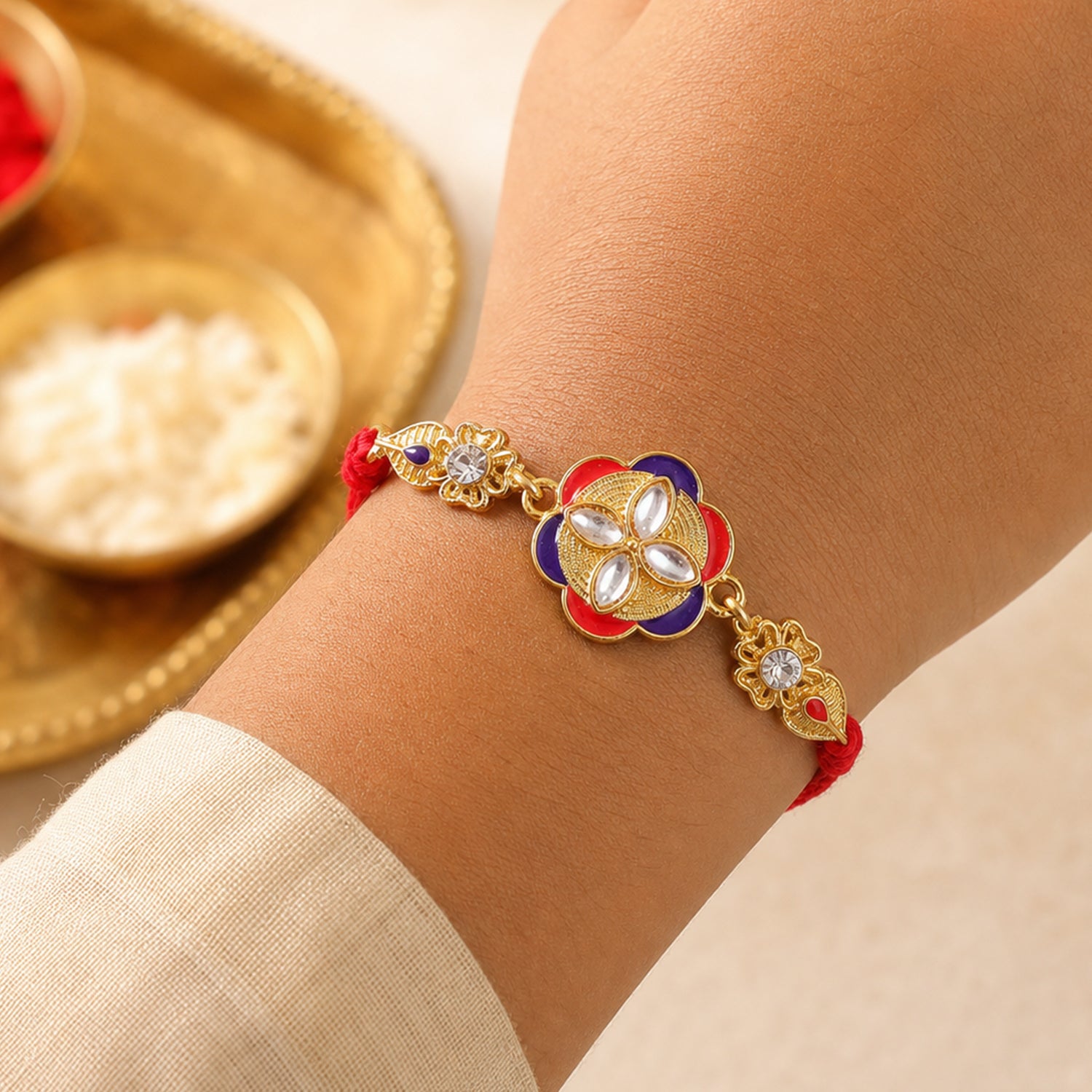 Festive Rakhi showcasing Decorative Rosette, pearl accents and bead line for Gifting