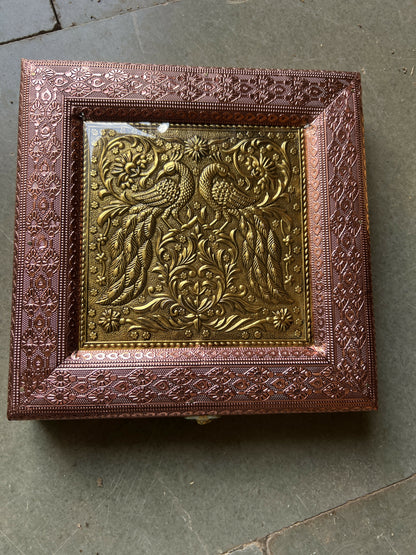 Top view showing clear protective layer on peacock embossed box